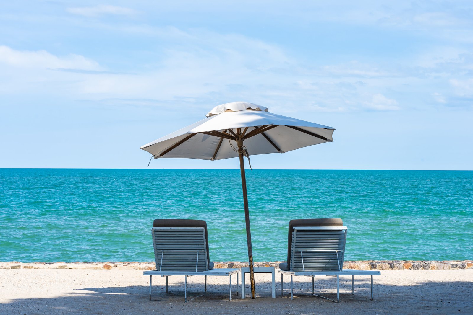 Beautiful umbrella and chair around beach sea ocean with blue sk